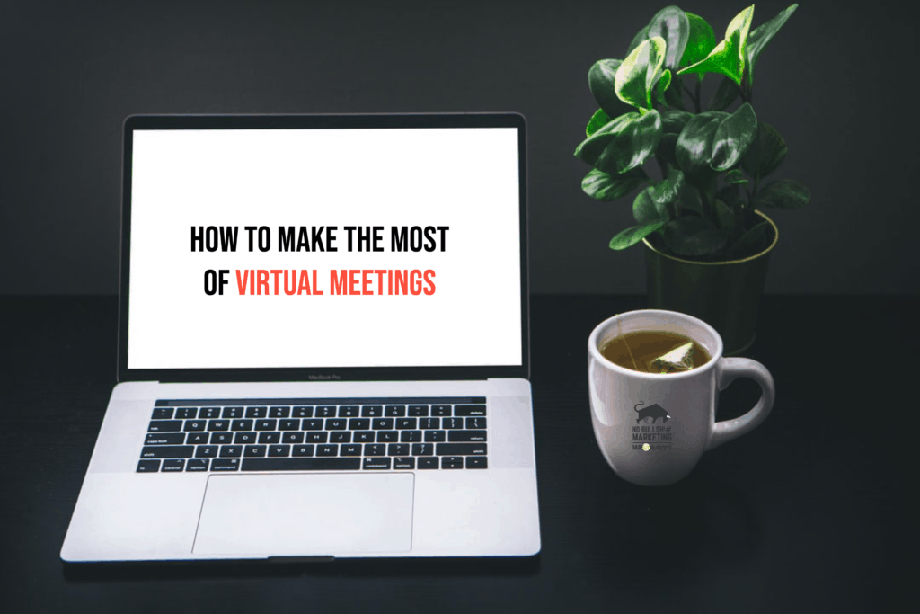 Blank laptop screen, cup of tea, and desk plant. Text on screen, "How to Make the Most of Virtual Meetings"